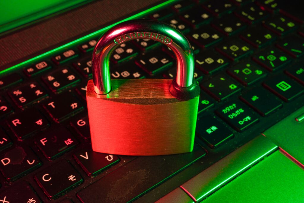 data security illustrated by a photo of a locked physical padlock resting on a laptop keyboard.